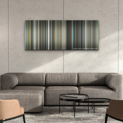 Spiderhead color palette canvas on a concrete wall above a gray sectional sofa
