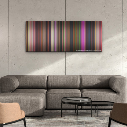 Encanto color palette canvas on a concrete wall above a gray sectional sofa