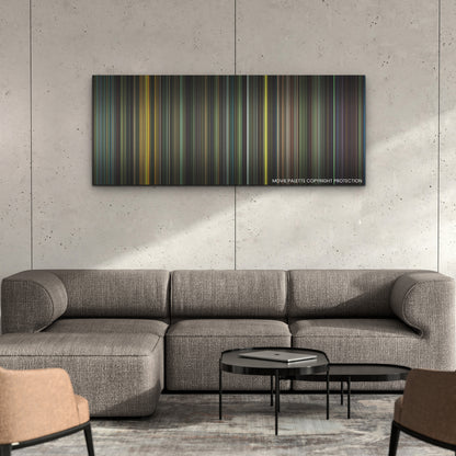 Spaceman color palette canvas on a concrete wall above a gray sectional sofa
