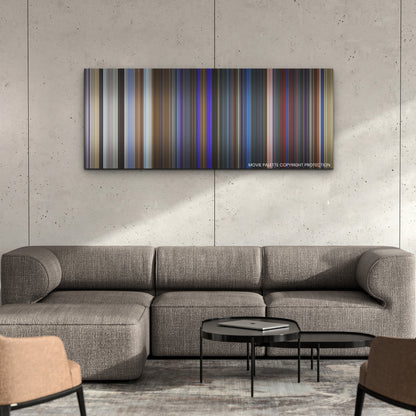 Blue Beetle color palette canvas on a concrete wall above a gray sectional sofa