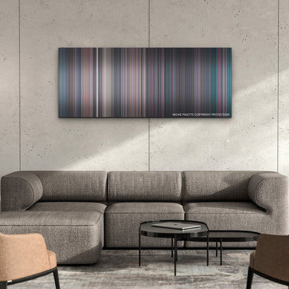 Terrifier 2 color palette canvas on a concrete wall above a gray sectional sofa