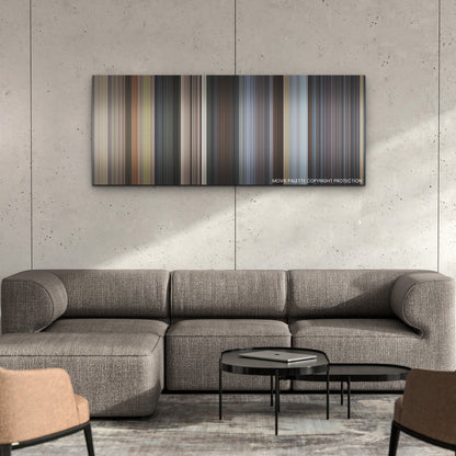 Ghosted color palette canvas on a concrete wall above a gray sectional sofa