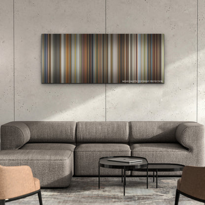 Three Thousand Years of Longing color palette canvas on a concrete wall above a gray sectional sofa
