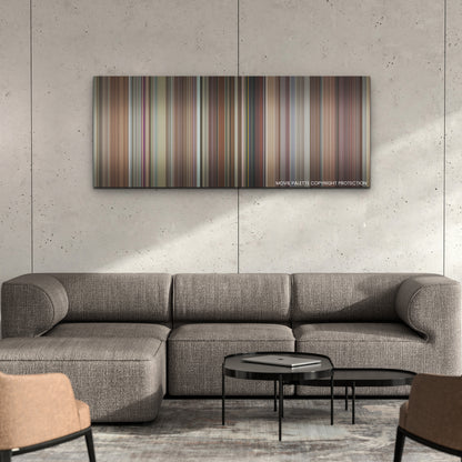 Hit Man color palette canvas on a concrete wall above a gray sectional sofa