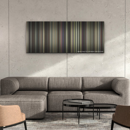 Priscilla color palette canvas on a concrete wall above a gray sectional sofa