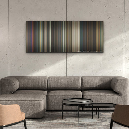 The Gray Man color palette canvas on a concrete wall above a gray sectional sofa