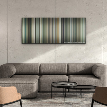 Guy Ritchie's the Covenant color palette canvas on a concrete wall above a gray sectional sofa