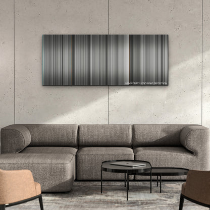 Belfast color palette canvas on a concrete wall above a gray sectional sofa