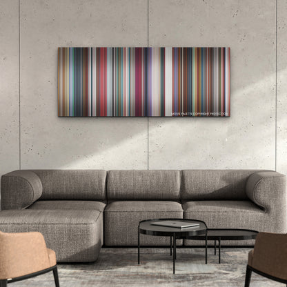 Nimona color palette canvas on a concrete wall above a gray sectional sofa