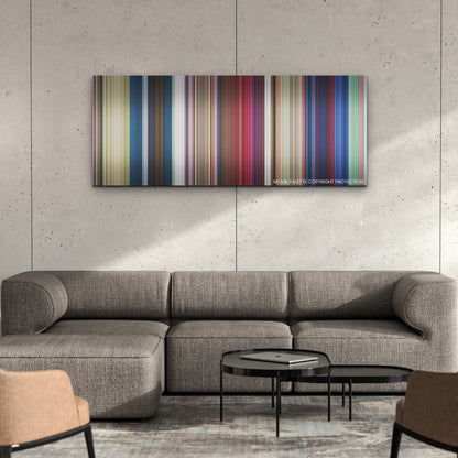 Migration color palette canvas on a concrete wall above a gray sectional sofa