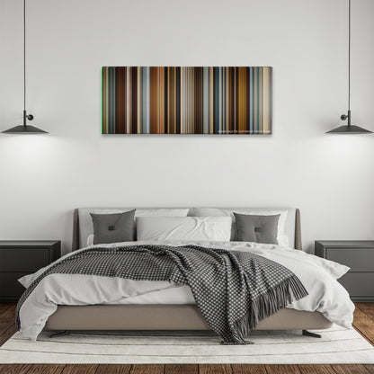 In Time color palette canvas above a bed, between two black pendant lamps
