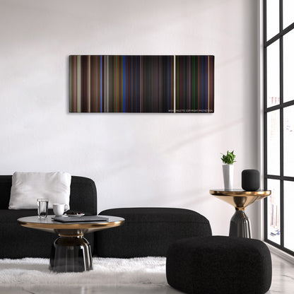 Beetlejuice color palette canvas above a black sofa with a gold-topped table