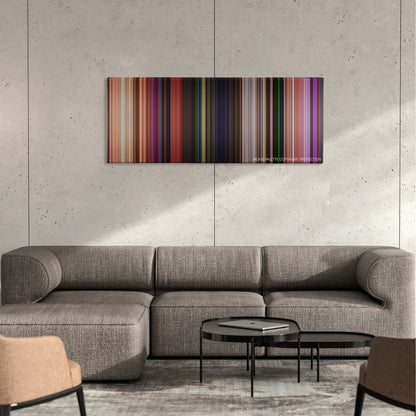 Onward color palette canvas on a concrete wall above a gray sectional sofa