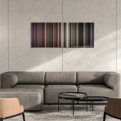 Donnie Brasco color palette canvas on a concrete wall above a gray sectional sofa