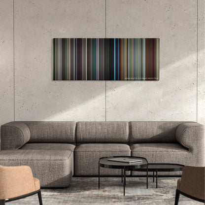 Stoker color palette canvas on a concrete wall above a gray sectional sofa