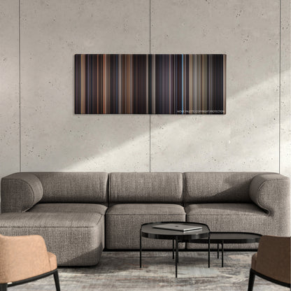 Frequency color palette canvas on a concrete wall above a gray sectional sofa