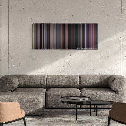 Creed color palette canvas on a concrete wall above a gray sectional sofa