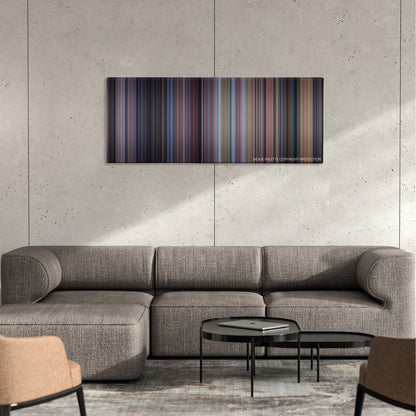 The Santa Clause color palette canvas on a concrete wall above a gray sectional sofa