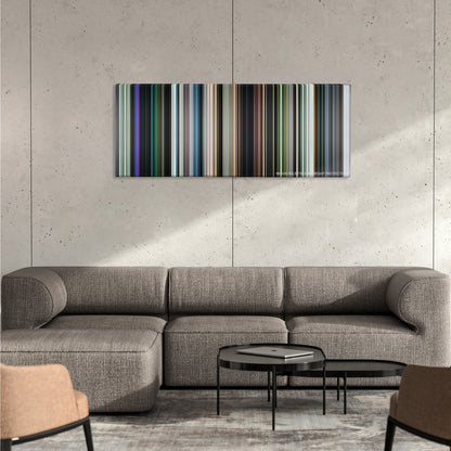 Chronicle color palette canvas on a concrete wall above a gray sectional sofa