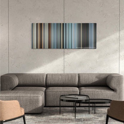 Sully color palette canvas on a concrete wall above a gray sectional sofa