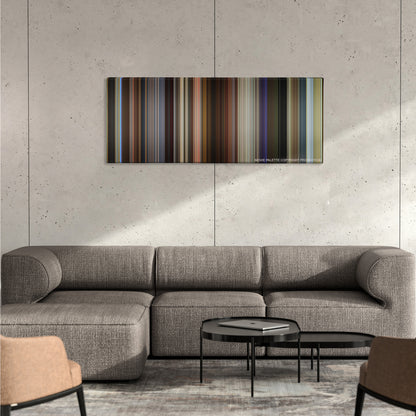 Spy color palette canvas on a concrete wall above a gray sectional sofa