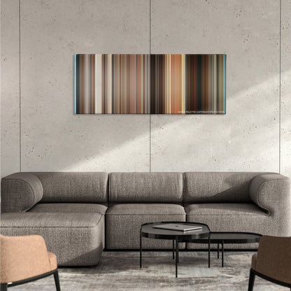 The Bucket List color palette canvas on a concrete wall above a gray sectional sofa