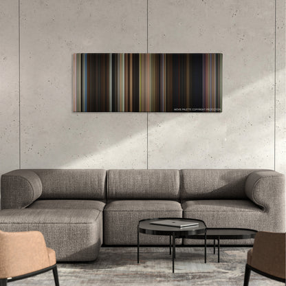 Alpha Dog color palette canvas on a concrete wall above a gray sectional sofa