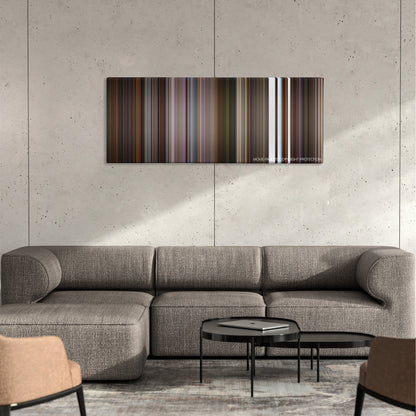 Little Nicky color palette canvas on a concrete wall above a gray sectional sofa
