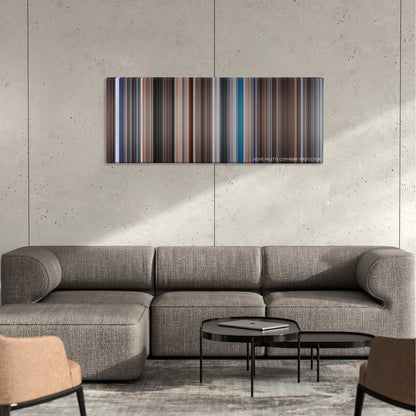 The Spy Who Loved Me color palette canvas on a concrete wall above a gray sectional sofa