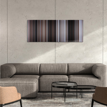 For a Few Dollars More color palette canvas on a concrete wall above a gray sectional sofa