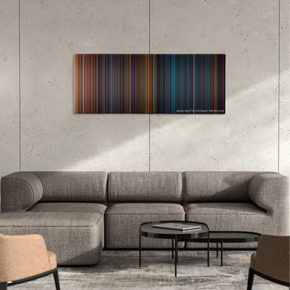 Poseidon color palette canvas on a concrete wall above a gray sectional sofa