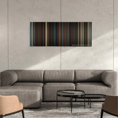 The Good Shepherd color palette canvas on a concrete wall above a gray sectional sofa