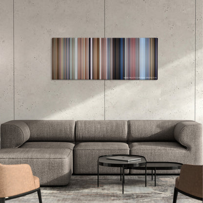 Bean color palette canvas on a concrete wall above a gray sectional sofa