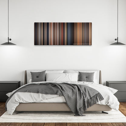Anaconda color palette canvas above a bed, between two black pendant lamps