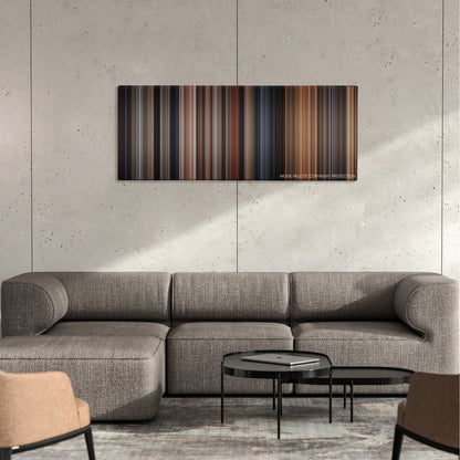 Anaconda color palette canvas on a concrete wall above a gray sectional sofa