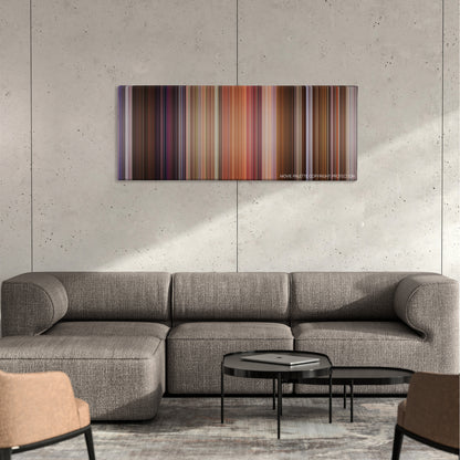 Bedazzled color palette canvas on a concrete wall above a gray sectional sofa