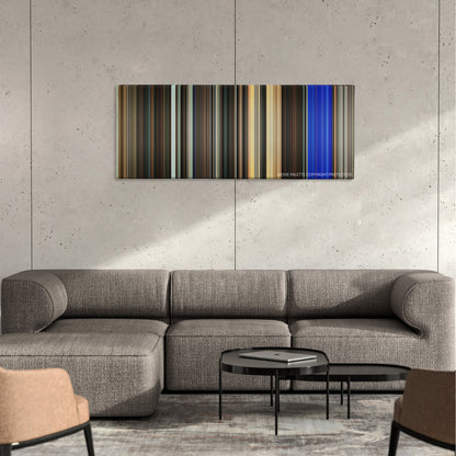Running Scared color palette canvas on a concrete wall above a gray sectional sofa