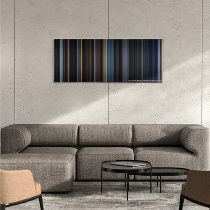 The Conjuring 2 color palette canvas on a concrete wall above a gray sectional sofa