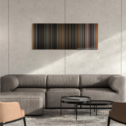 Identity color palette canvas on a concrete wall above a gray sectional sofa