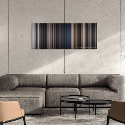 Tango & Cash color palette canvas on a concrete wall above a gray sectional sofa