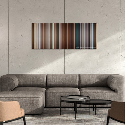 Long Shot color palette canvas on a concrete wall above a gray sectional sofa