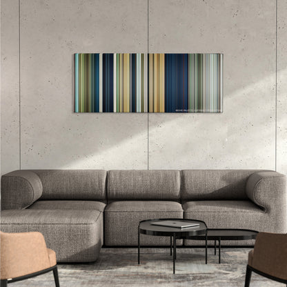 Rambo color palette canvas on a concrete wall above a gray sectional sofa