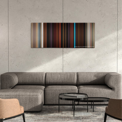 Booksmart color palette canvas on a concrete wall above a gray sectional sofa