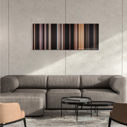 Ben-Hur color palette canvas on a concrete wall above a gray sectional sofa
