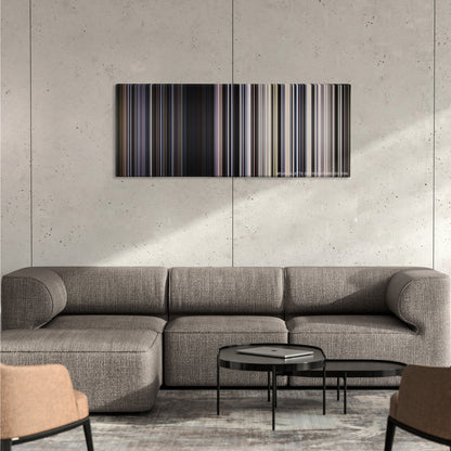 Transcendence color palette canvas on a concrete wall above a gray sectional sofa