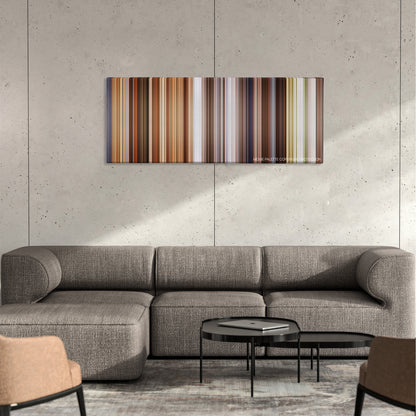 Jobs color palette canvas on a concrete wall above a gray sectional sofa