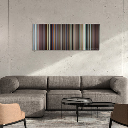 Ali color palette canvas on a concrete wall above a gray sectional sofa