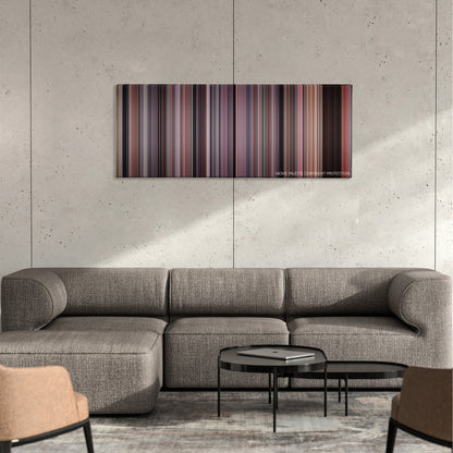 Cellular color palette canvas on a concrete wall above a gray sectional sofa