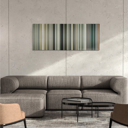 Jason Bourne color palette canvas on a concrete wall above a gray sectional sofa