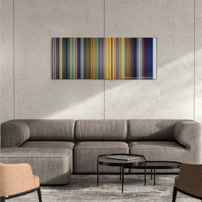 Tarzan color palette canvas on a concrete wall above a gray sectional sofa